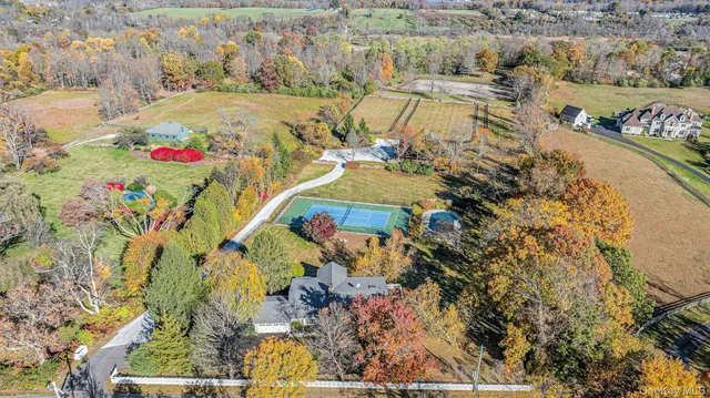 a view of a big house in a big yard with large trees