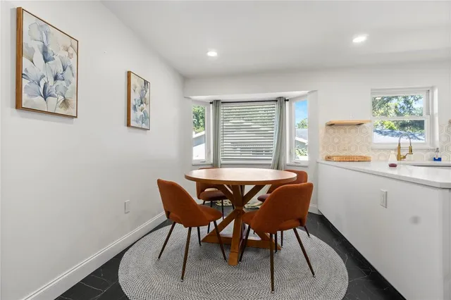 a view of a dining room with furniture window and outside view