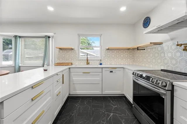 a kitchen with a stove oven and sink