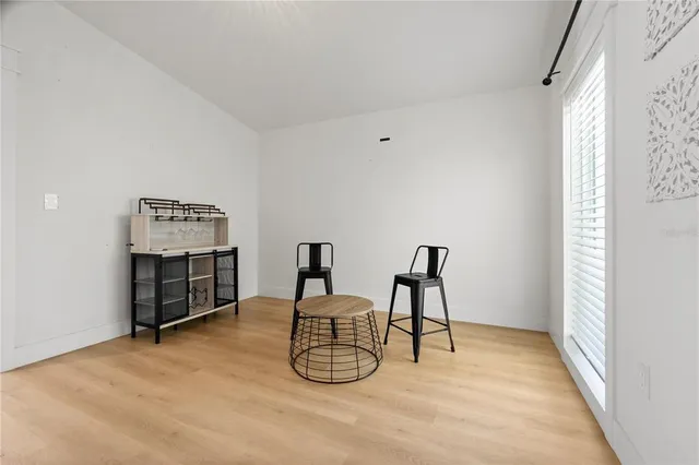 a view of a room with furniture and window