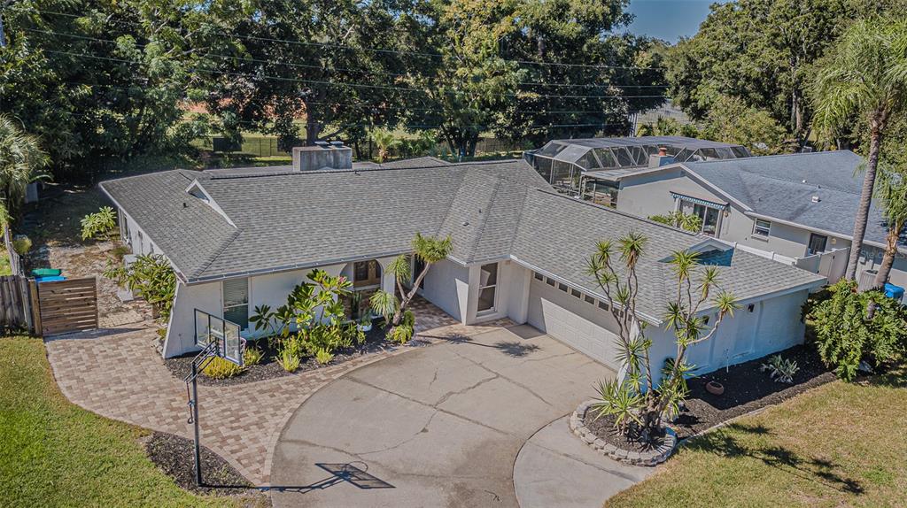565 Sandy Hook Road Palm Harbor, FL 34683 - Photo 2 of 33 an aerial view of a house with a yard potted plants and large tree