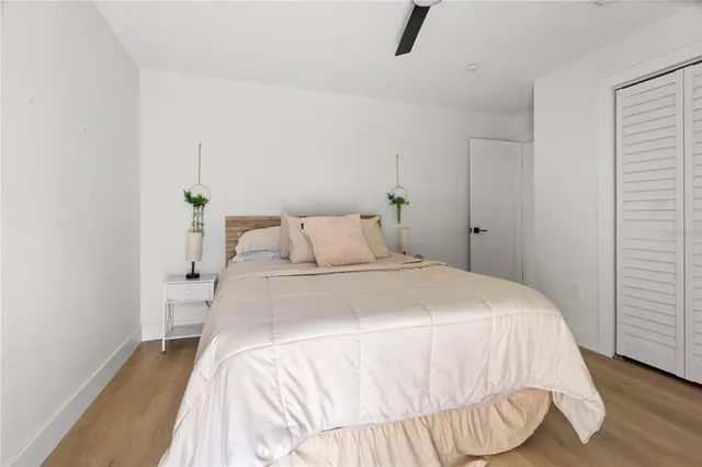 a bedroom with a bed and a wooden floor