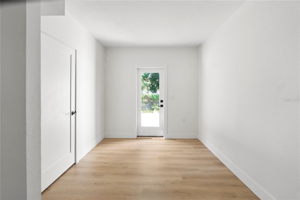 565 Sandy Hook Road Palm Harbor, FL 34683 - Photo 27 of 33 a view of an empty room with wooden floor and a window
