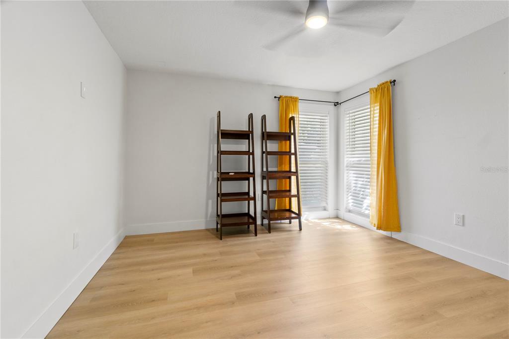 565 Sandy Hook Road Palm Harbor, FL 34683 - Photo 28 of 33 wooden floor in an empty room with a window