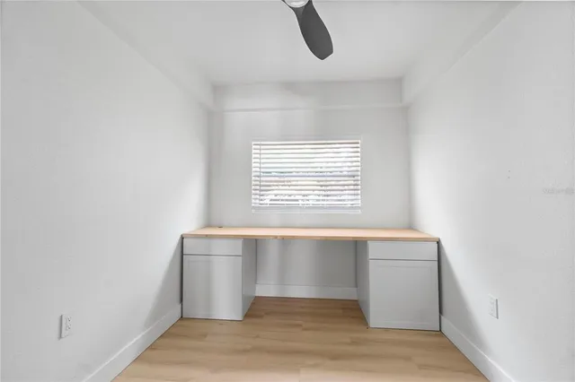 a room with a window and a wooden floor