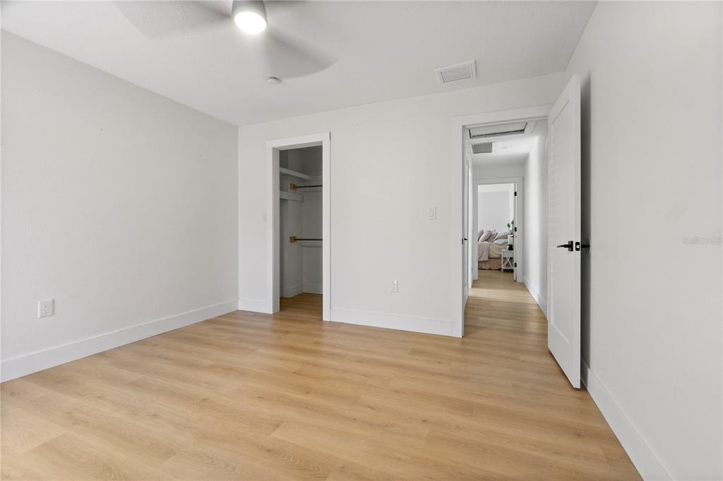 565 Sandy Hook Road Palm Harbor, FL 34683 - Photo 30 of 33 a view of a hallway with wooden floor and a bathroom