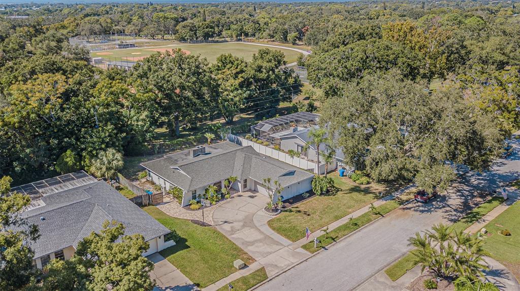 565 Sandy Hook Road Palm Harbor, FL 34683 - Photo 3 of 33 an aerial view of a house with a lake view