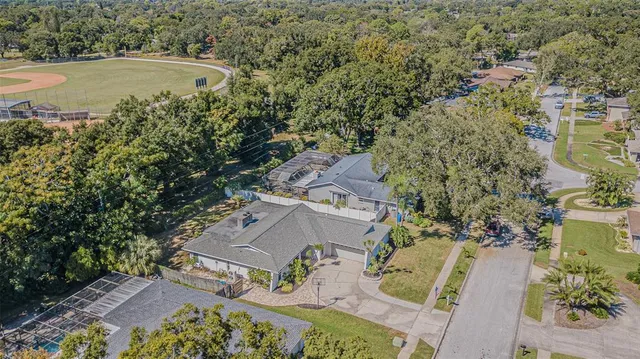 an aerial view of a house with outdoor space and swimming pool