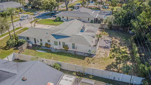 an aerial view of residential houses with outdoor space and parking