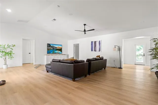 a living room with furniture and a wooden floor