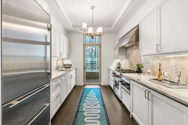a kitchen with a stove and a chandelier