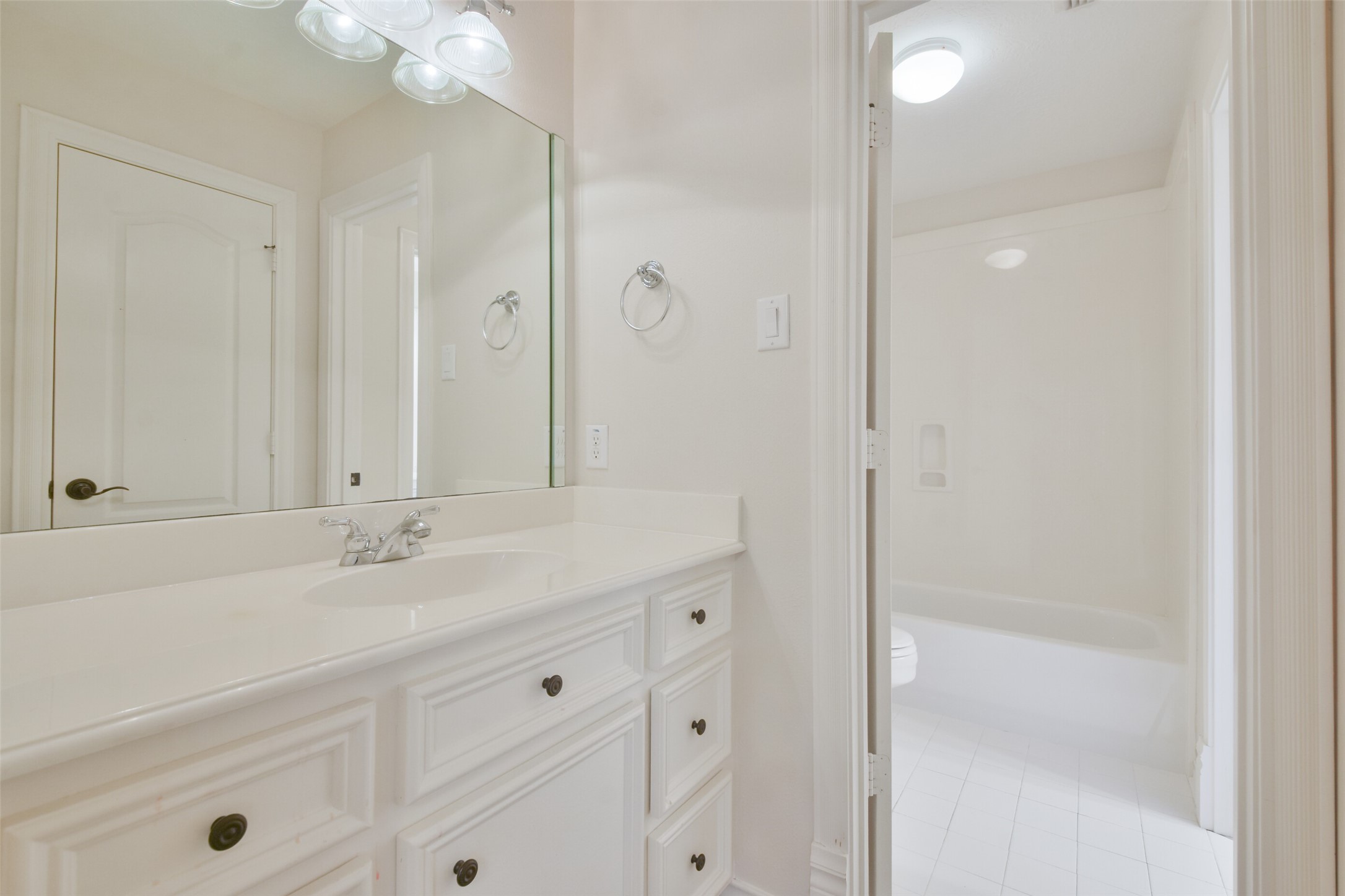 8114 Hideaway Lake Circle Spring, TX 77389 - Photo 34 of 50 a bathroom with a shower sink vanity and mirror