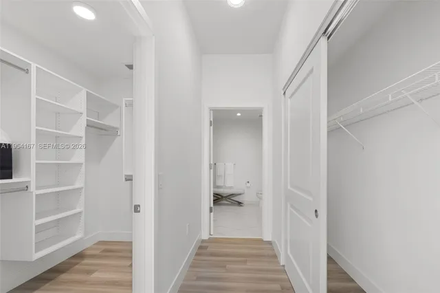 a bedroom with furniture and a large window