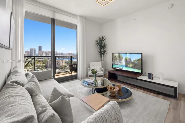 a living room with furniture and a flat screen tv