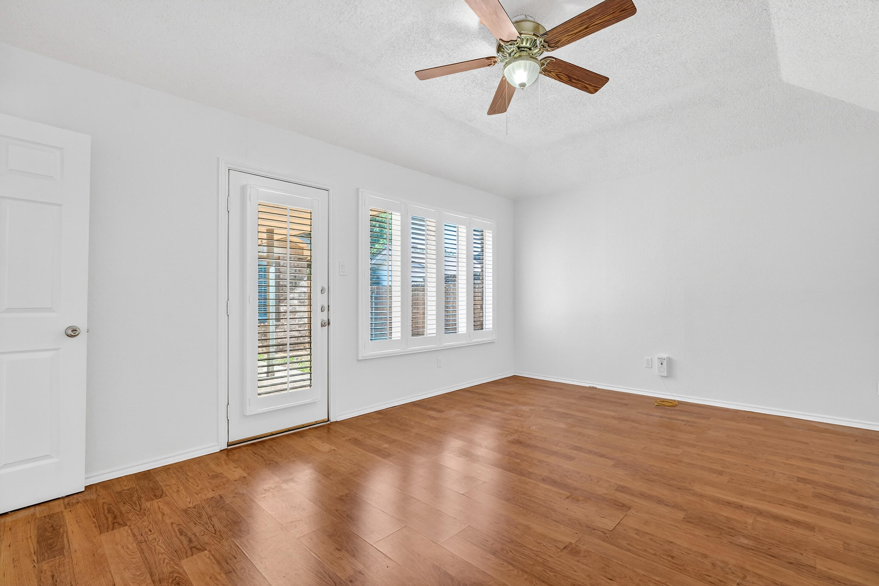 5221 84th Street Lubbock, TX 79424 - Photo 15 of 26 wooden floor in an empty room with a window