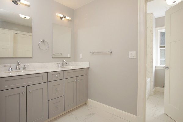 255 Clark Road Brookline, MA 02445 - Photo 8 of 9 a bathroom with a double vanity sink and a mirror