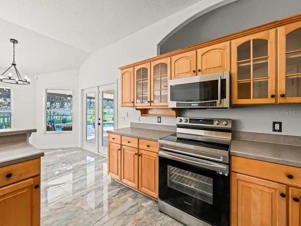 a kitchen with stainless steel appliances a stove sink and microwave