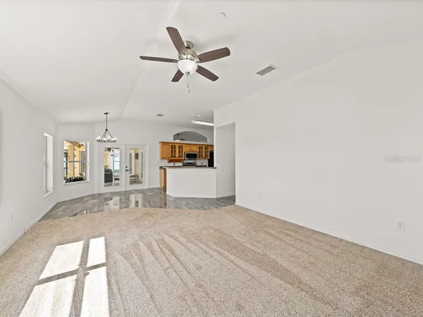a view of a livingroom with a window and a ceiling fan