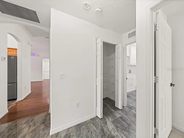 a view of a hallway with wooden floor