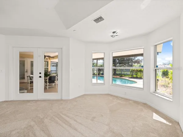 a view of a livingroom with a ceiling fan and window