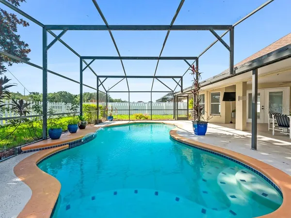 a view of a swimming pool with a patio