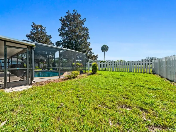 a view of a house with backyard and sitting area