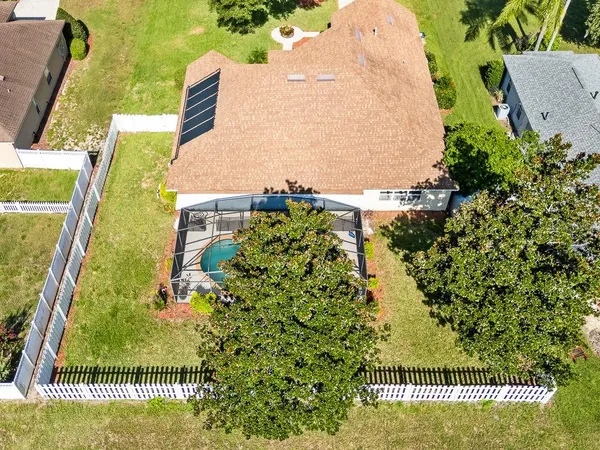 an aerial view of a house with a yard and lake view