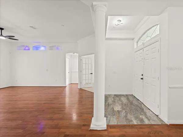 a view of empty room with wooden floor