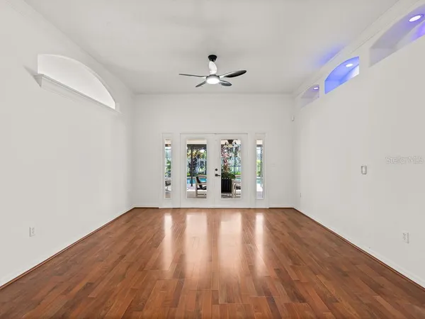 wooden floor in an empty room with a window