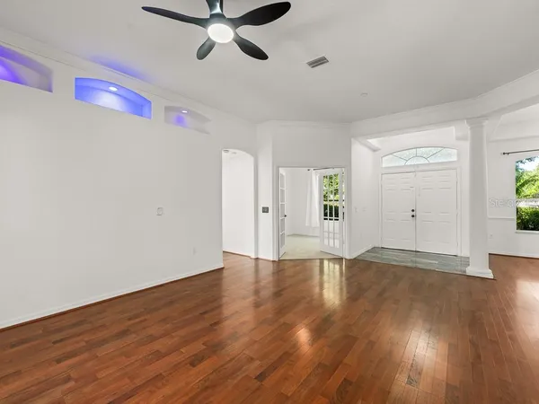 a view of an empty room with wooden floor