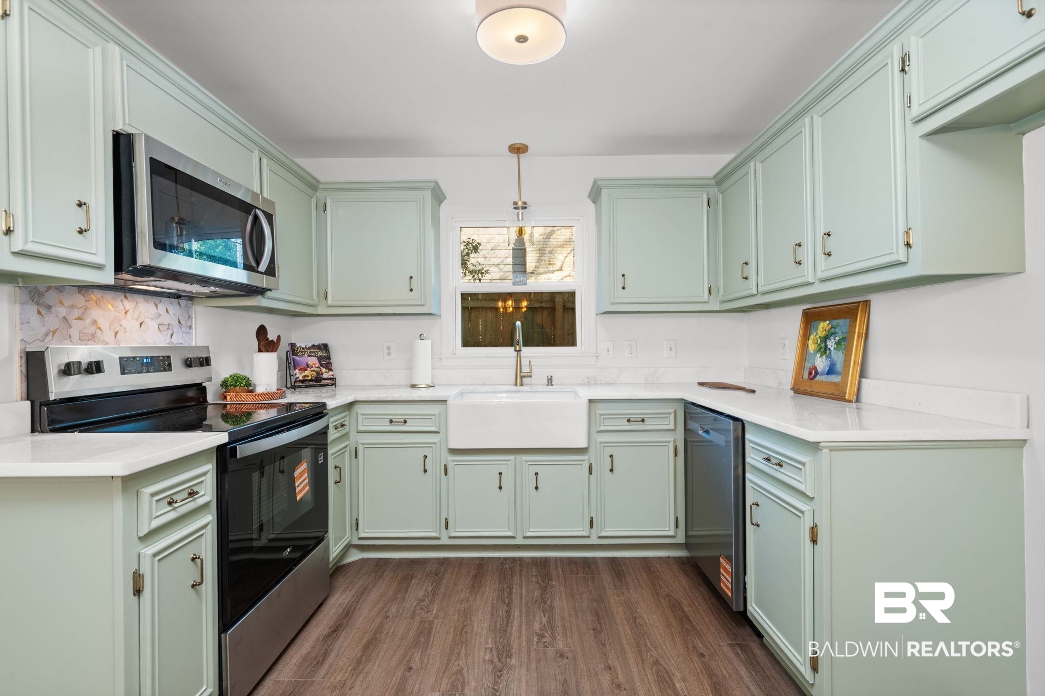 511 Wacker Lane North Mobile, AL 36608 - Photo 21 of 45 Kitchen with stainless steel appliances, light stone counters, dark wood-type flooring, and green cabinets