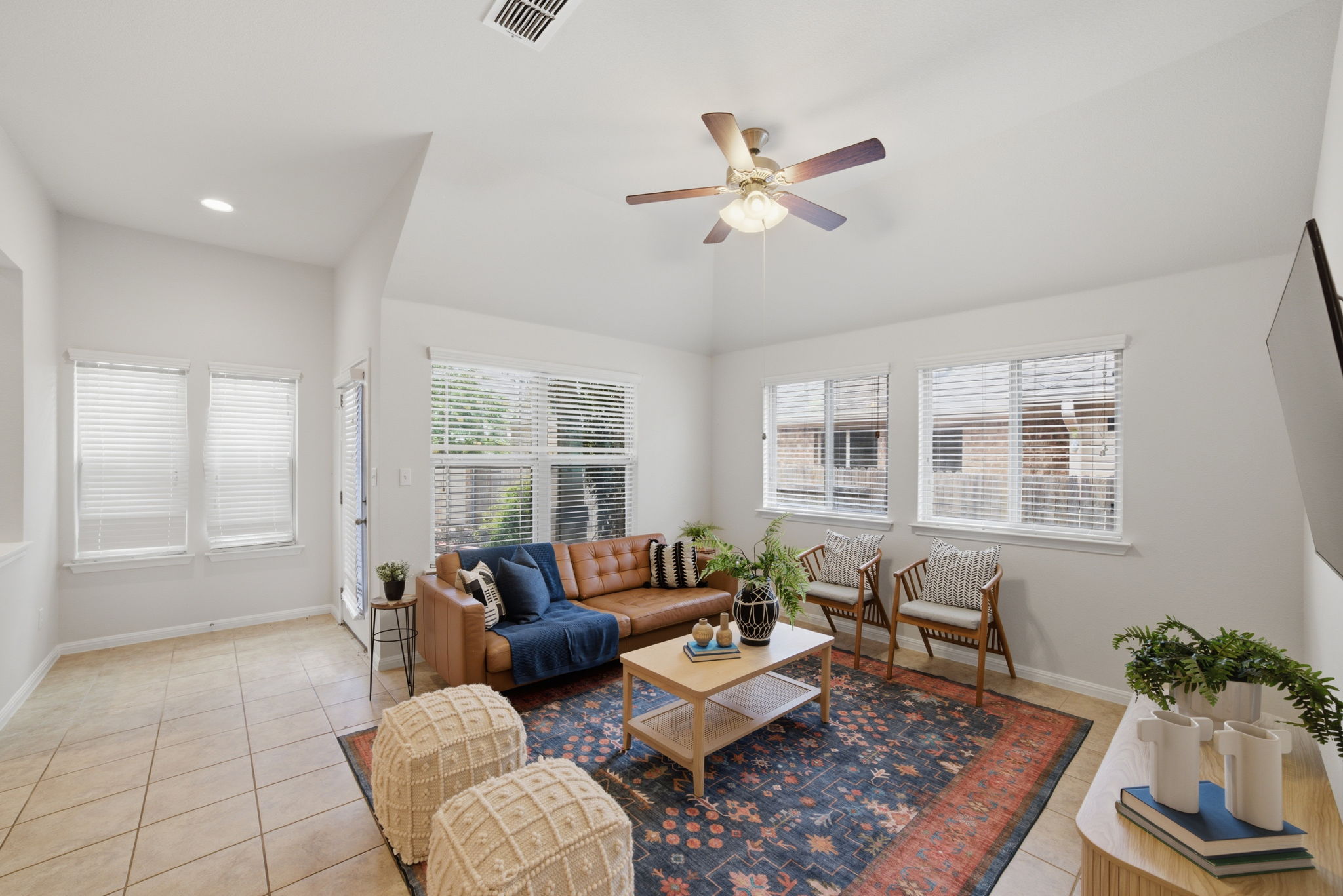 514 Nautical Loop Kyle, TX 78640 - Photo 5 of 24 The inviting living area features a cathedral ceiling, tile flooring, and multiple sun-filled windows.