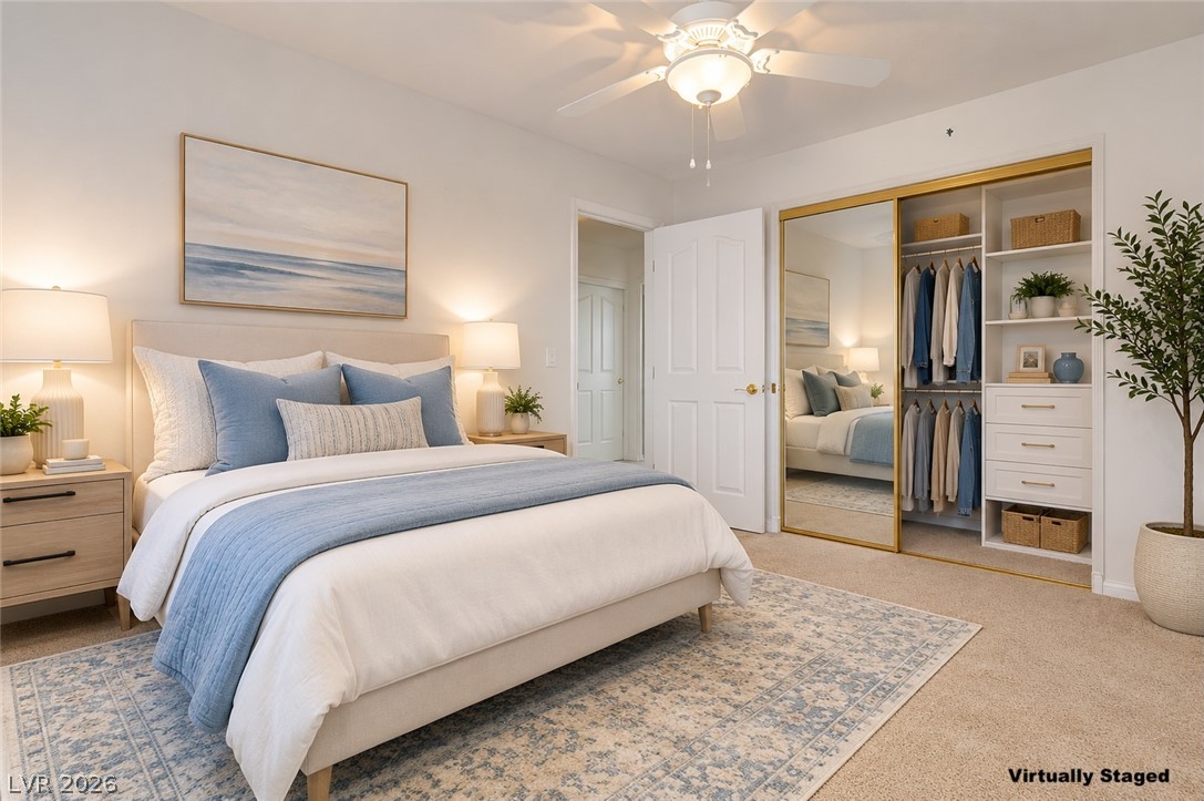 1479 Orange Jubilee Road Henderson, NV 89014 - Photo 23 of 36 Comfortable carpet and a ceiling fan create a serene and inviting atmosphere in this bedroom retreat.