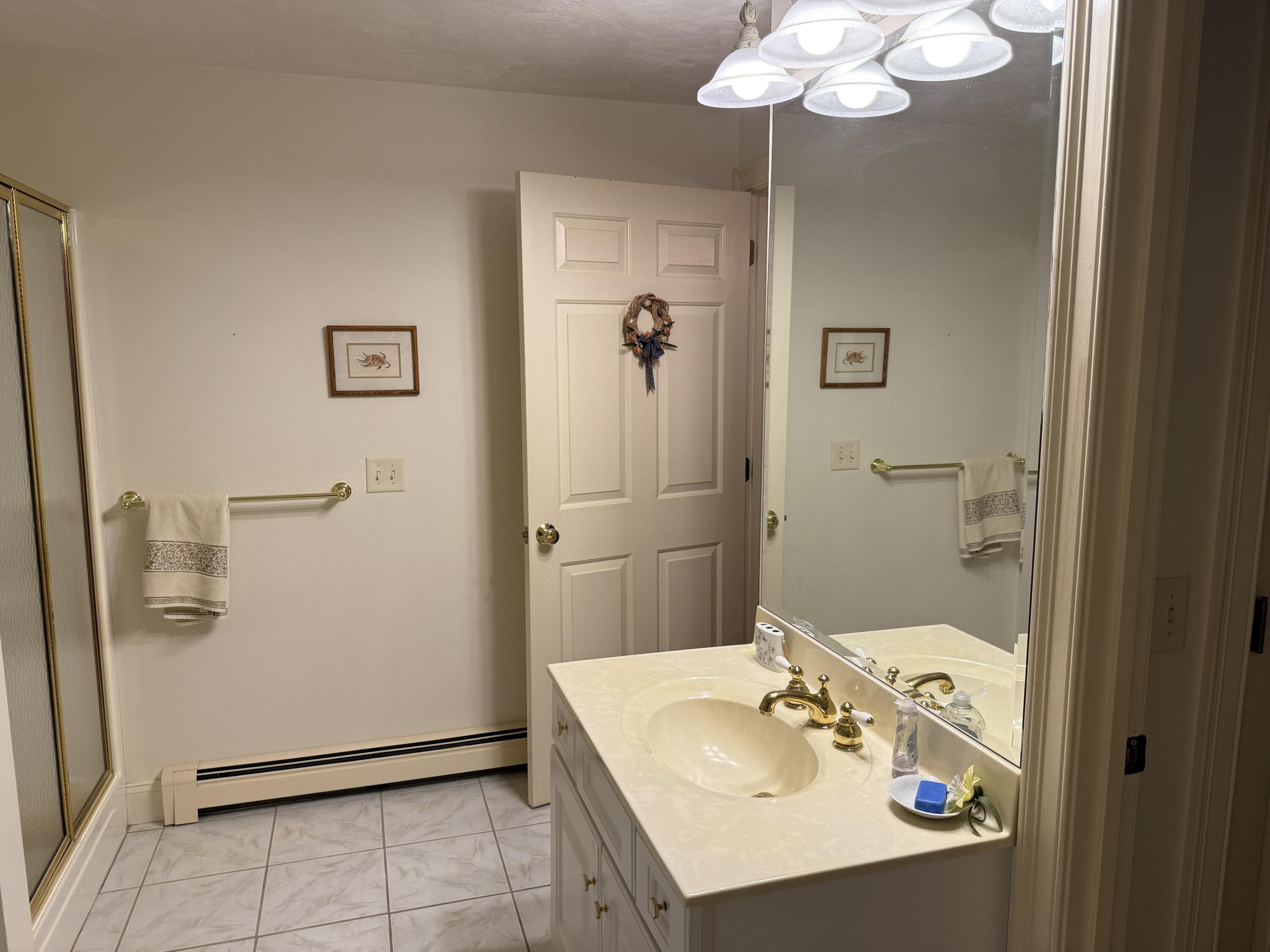 403 Lower County Road, Unit A Harwich Port, MA 02646 - Photo 11 of 12 a bathroom with a sink a toilet and shower