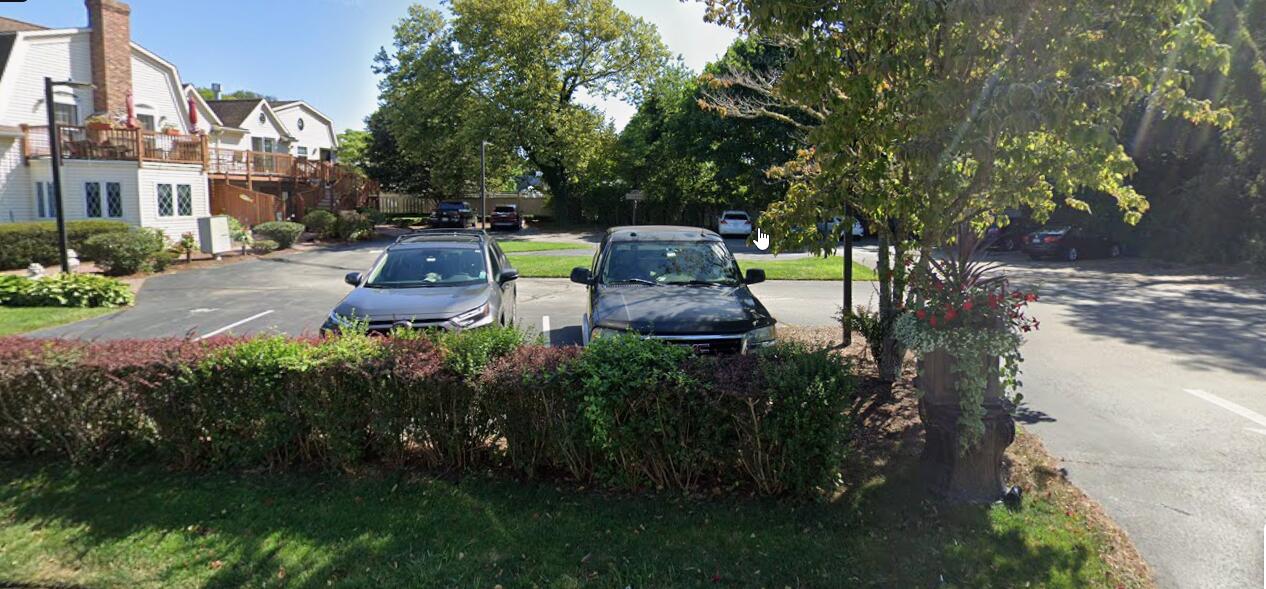 403 Lower County Road, Unit A Harwich Port, MA 02646 - Photo 12 of 12 a view of a garden with plants and a bench