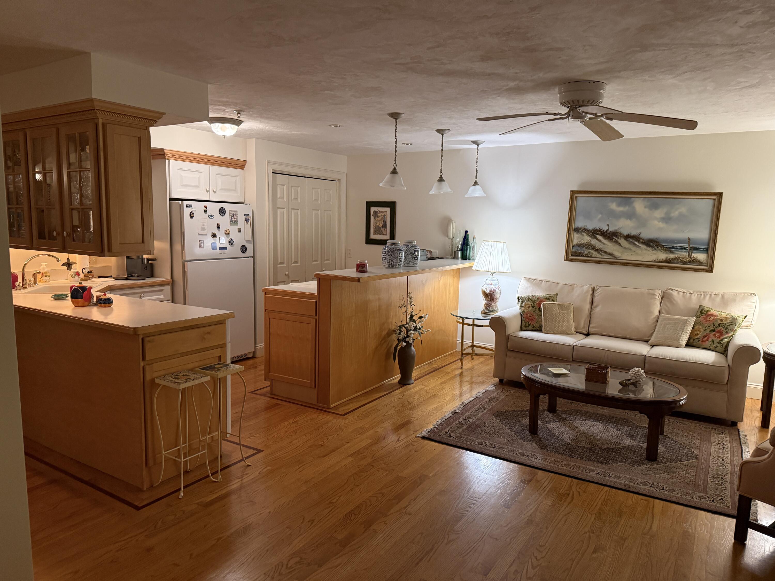 403 Lower County Road, Unit A Harwich Port, MA 02646 - Photo 2 of 12 a living room with furniture and a wooden floor