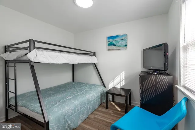 a bedroom with furniture and a window