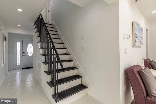 a view of entryway and hall with wooden floor