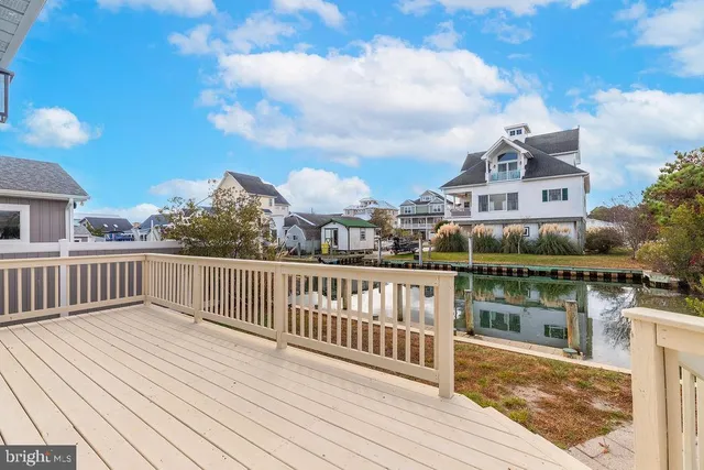 a view of balcony with wooden floor and fence