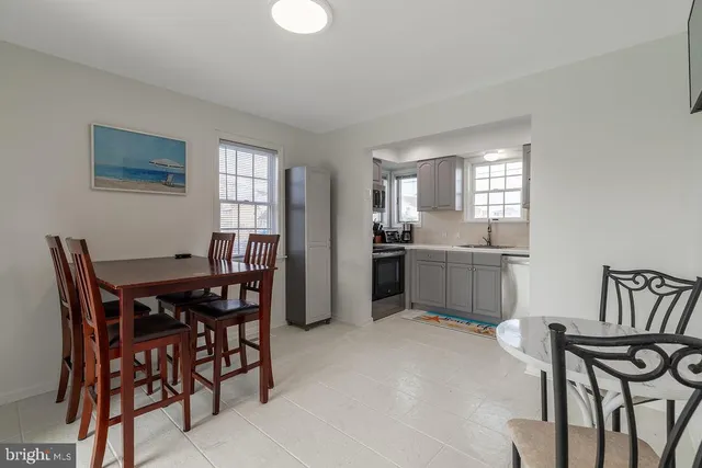 a kitchen with sink cabinets and dining table
