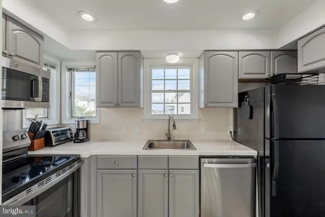 a kitchen with stainless steel appliances a refrigerator stove and sink