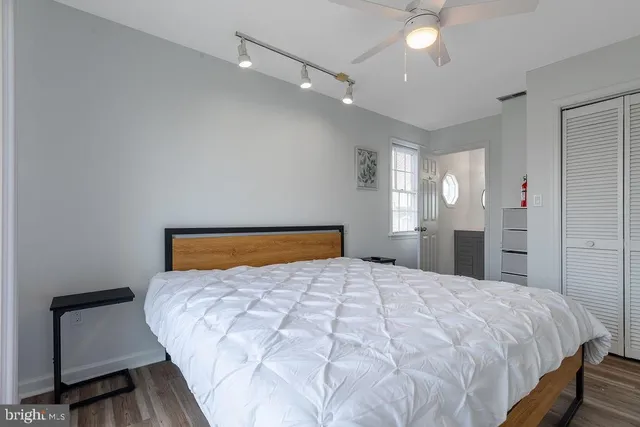 a bedroom with a large bed and a chandelier
