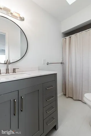 a bathroom with a sink vanity and a mirror
