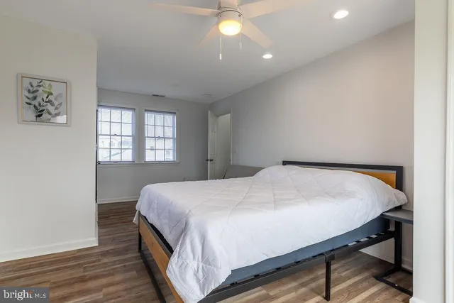 a bed sitting in a bedroom next to a window