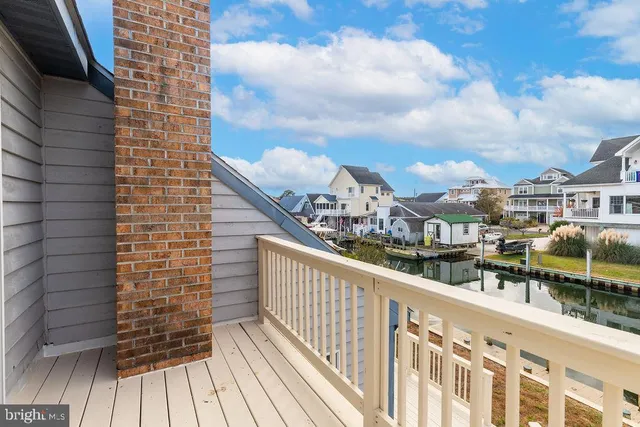 a view of balcony with two chairs and wooden floor