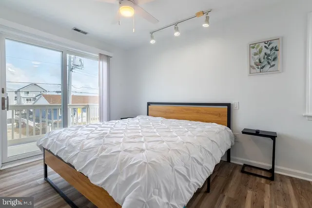 a large bed sitting in a bedroom next to a window