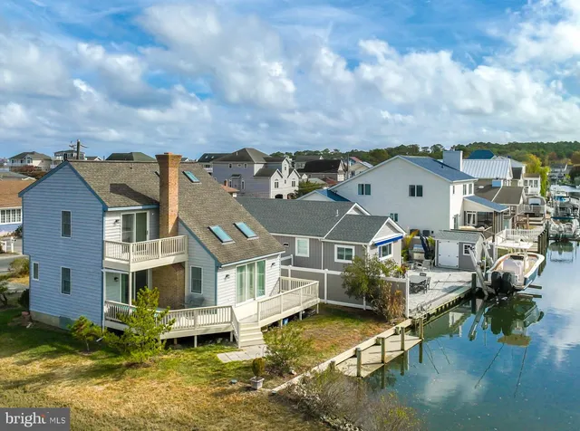 an aerial view of residential houses with yard