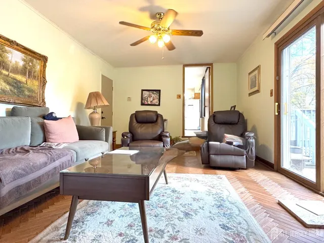 a living room with furniture fireplace and a large window