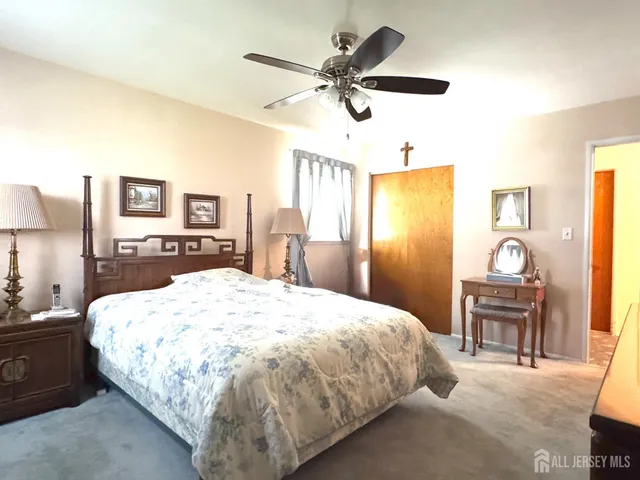 a bed room with a bed mirror and a desk