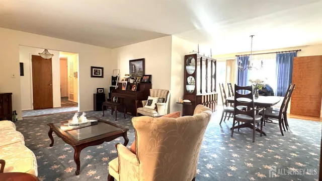 a living room with furniture and large windows